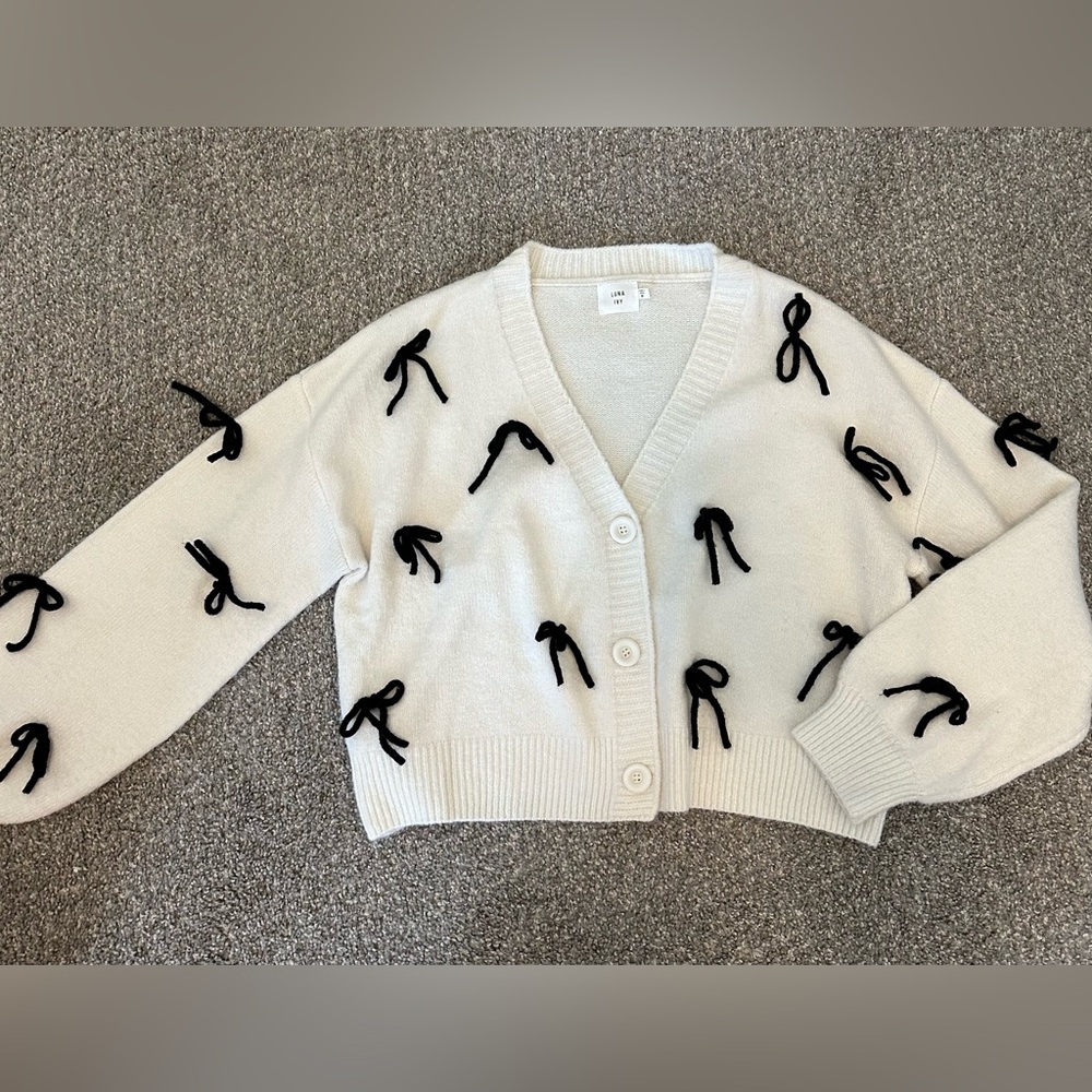 Cream V-Neck Button Cardigan with Black Bow Accents